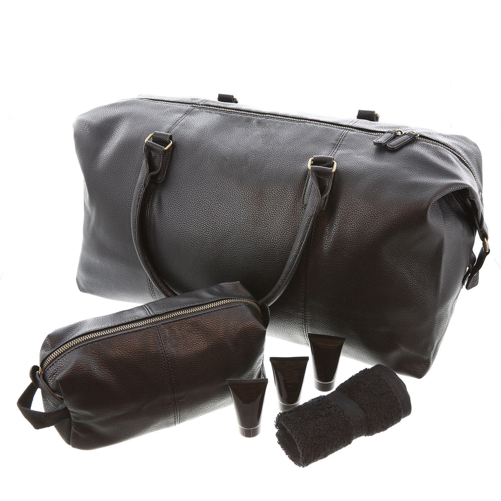 Set of black leather travel bags and accessories on a white background