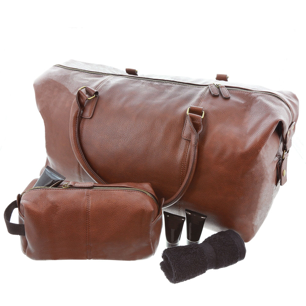 Brown leather duffel bag with a smaller pouch and black sock on a white background