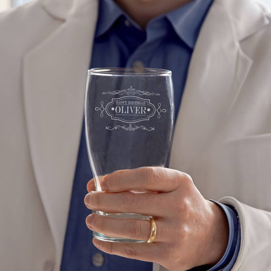 man holding glass with vintage style label