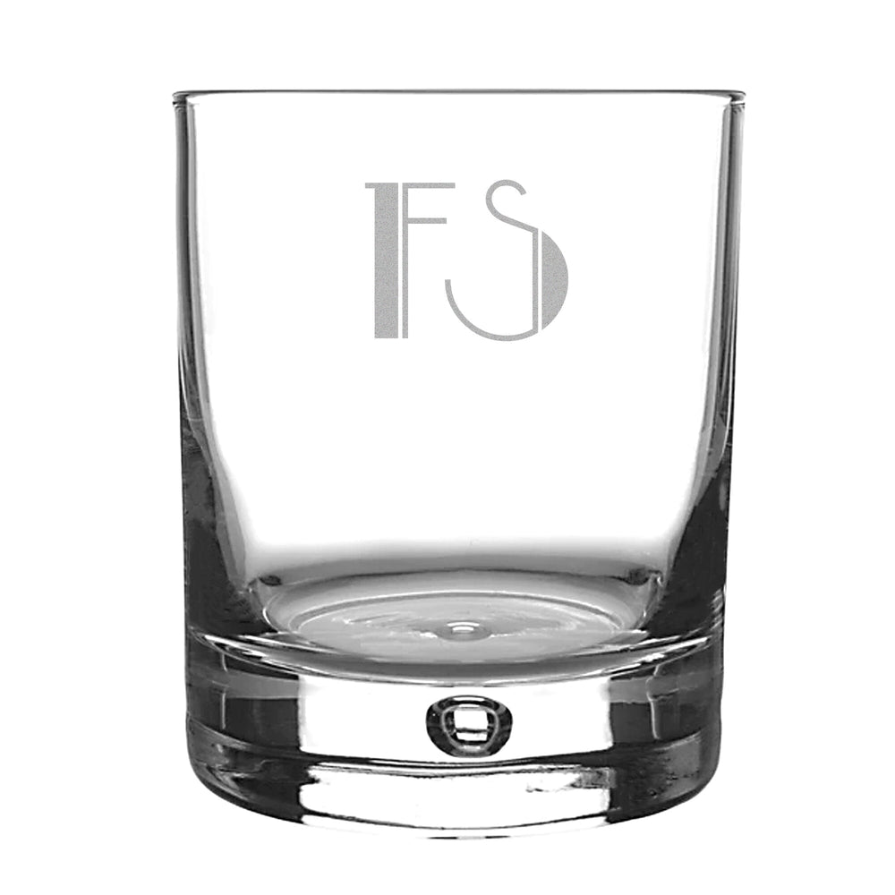 engraved whiskey glass with initials with white backdrop