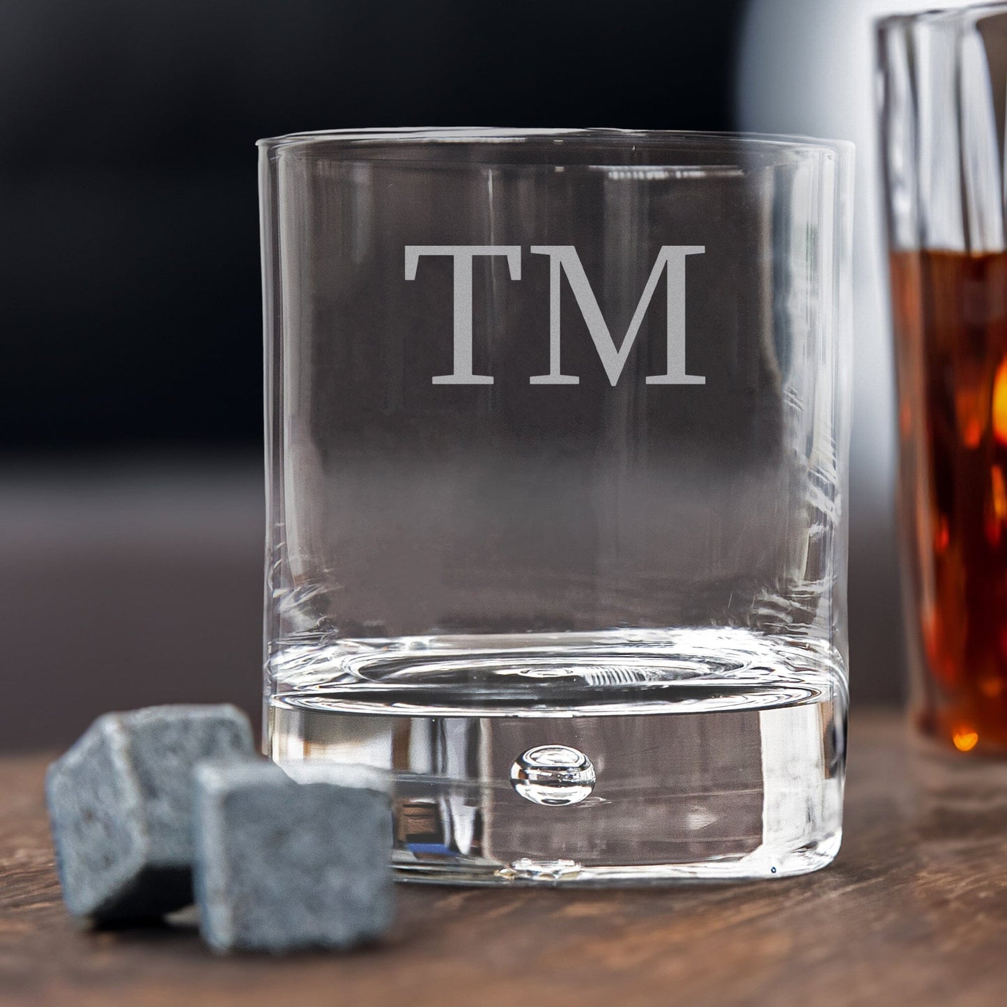 Engraved whiskey glass with whiskey next to it