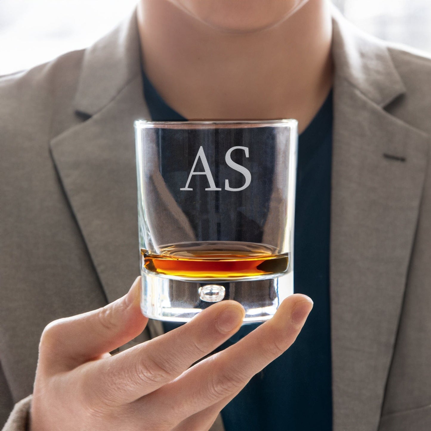 Male male model holding the Engraved whiskey glass