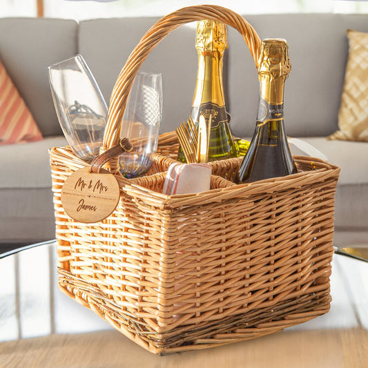 A personalised wicker wine carrier basket on a coffee table featuring a personalised round cherry wood veneer tag
