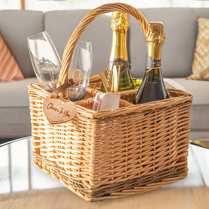 A personalised wicker wine carrier on a coffee table. Featuring a personalised hear-shaped cherry wood veneer tag