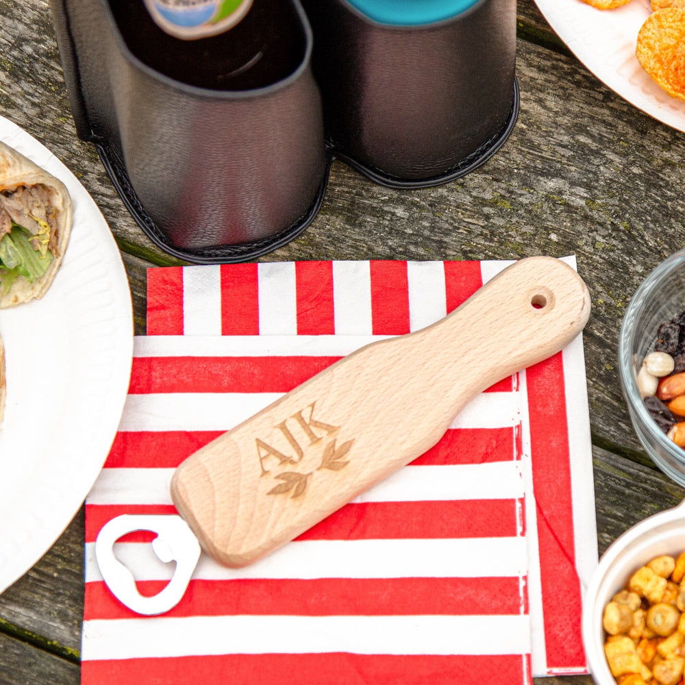 Personalised Wooden Botttle opener with initials on the picnic table