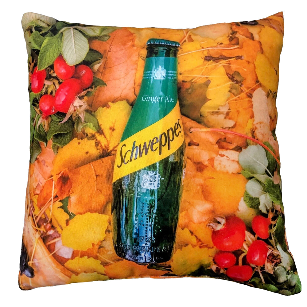 Pillow with Schweppes ginger ale bottle and autumn-themed design