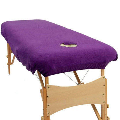 purple couch cover with a face hole on a portable massage table