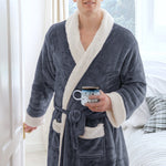 man wearing a sherpa robe holding a mug