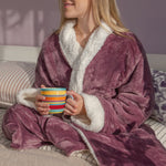 woman wearing a sherpa robe holding a mug