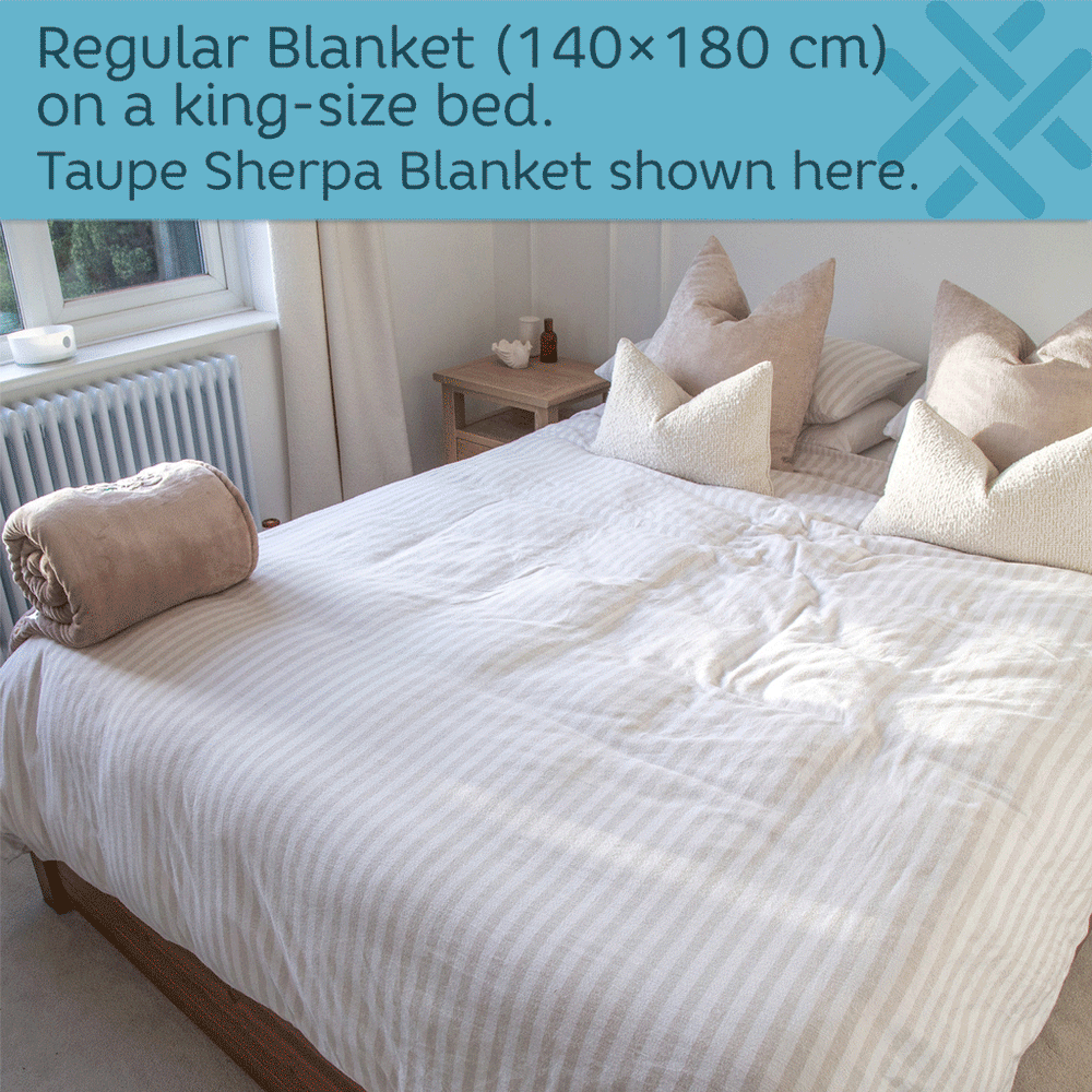 sherpa blanket unrolled onto a king size bed