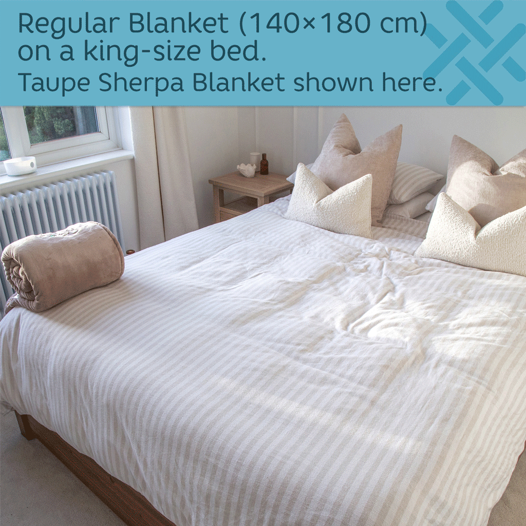 sherpa blanket unrolled onto a king size bed