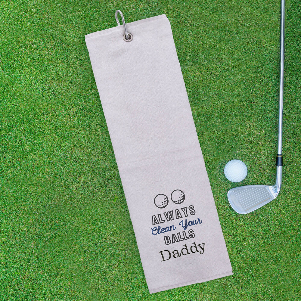 Golf towel with humorous text on a green golf course