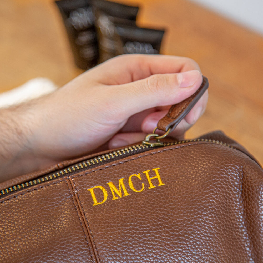 Close up of brown wash bag with embroidery