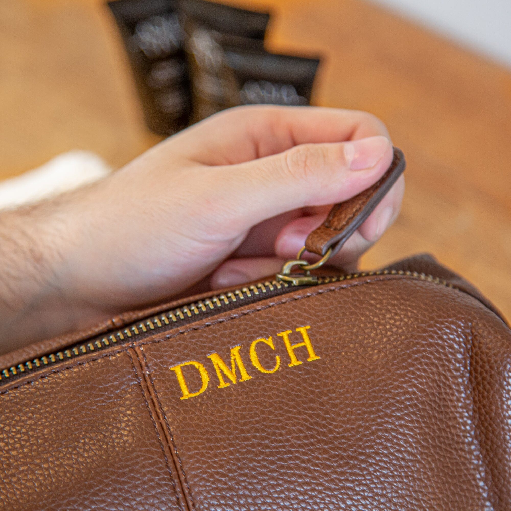 Close up of brown wash bag with embroidery
