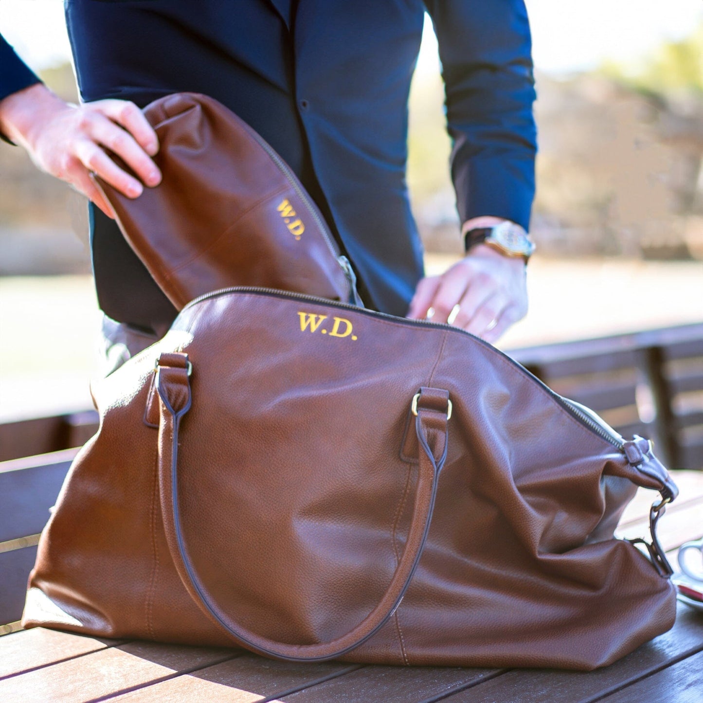 Personalised vintage holdall and wash bag set brown outdoor on the table