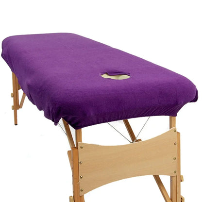 purple couch cover with a face hole on a portable massage table