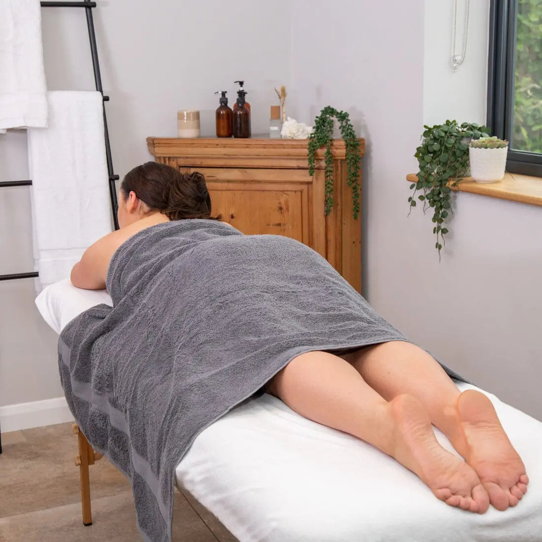 women on a massage bed, in a treatment room
