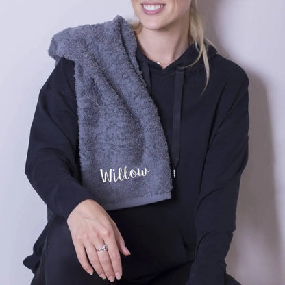 Lifestyle image of a lady with a personalised gym towel draped over her shoulder