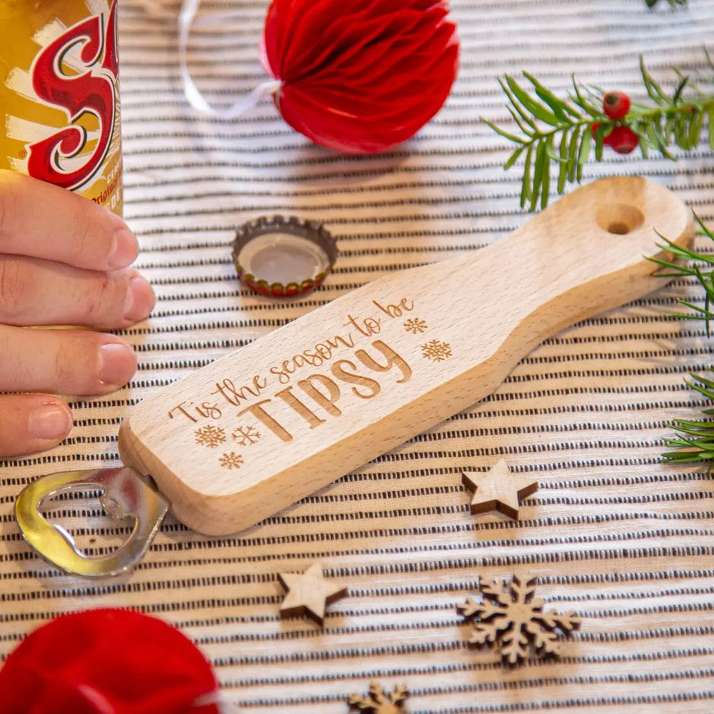 Christmas Wooden Long Handled Bottle Opener with beer and Christmas props around