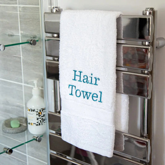 teal coloured personalisation on a white hand towel