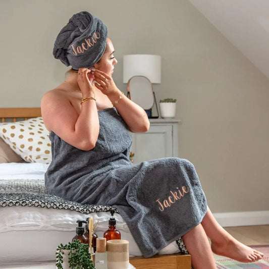 lifestyle shot of a woman wearing the products on a bed