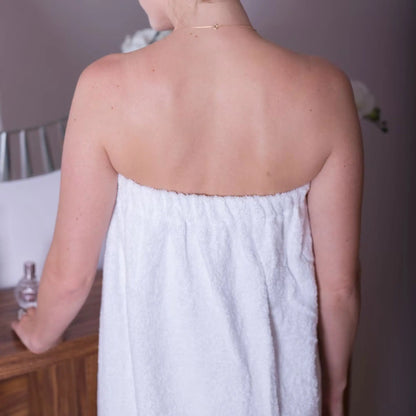back of a women wearing white sarong, showing the elasticated fit